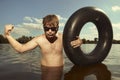 Retro man in summer lake have fun with inner tube