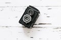 Retro medium format camera on wood table background, vintage concept, text space