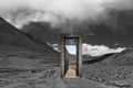 Retro metal door on the road in the mountains. dramatic collage.