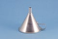 Retro metal funnel hopper tool on blue background