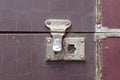 Retro metal latch on a brown closed suitcase close up