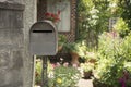 Retro metal mail box in front of a house Royalty Free Stock Photo