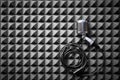 Retro microphone with cable lying on acoustic foam panel background Royalty Free Stock Photo
