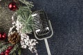 Retro microphone with Christmas decor on abstract background. Christmas music Royalty Free Stock Photo