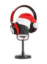 Retro microphone with Santa hat and headphones on background. Christmas music concept Royalty Free Stock Photo