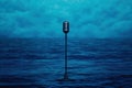 Vintage Microphone on Stand in Ocean Dramatic Stage Lighting Blue Water Background Royalty Free Stock Photo