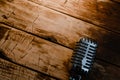 Retro microphone on warm wooden background