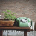 Retro mint green rotary telephone on wood table