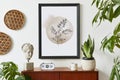 Retro modern compositon of living room interior with design teak commode, black mock up poster frame, clock, plant, decoration. Royalty Free Stock Photo