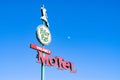 Retro motel sign from an abandoned motel deep in rural US against clear blue sky.