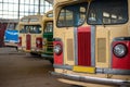 Retro multi-colored buses in a large garage