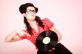 Retro music. Pinup girl with vinyl record Royalty Free Stock Photo