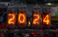 retro Nixie lamp indicator clock on dark background 2024 number