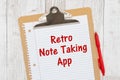 Retro Note Taking App humorous message on lined paper with a pen on a clipboard Royalty Free Stock Photo