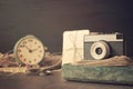 Retro old camera with pile of photos, letters, malachite box and antique watches on wooden background. Memories, nostalgia, Royalty Free Stock Photo