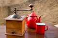 Retro old coffee grinder with vintage red teapot Royalty Free Stock Photo