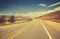 Retro old film style country highway in USA. Royalty Free Stock Photo