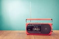 Retro old outdated red portable radio cassette recorder from 80s front blue background. Vintage style filtered photo Royalty Free Stock Photo