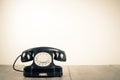 Retro old rotary telephone on wooden table. Vintage style sepia photography Royalty Free Stock Photo