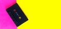 Retro old school 80-s or 90-s concept. Black Audio cassette on a pink yellow creative background