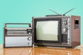 Retro old TV set and FM radio receiver. Broadcasting concept on the wooden desk. 3D rendering Royalty Free Stock Photo