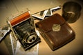 Retro old vintage outdated manual film camera circa 1940s, developed negative films, vintage photo album and leather camera case Royalty Free Stock Photo