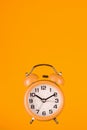 Orange alarm clock on black background