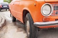 Retro orange car, old rusty machine, foreground close-up