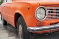 Retro orange car, old rusty machine, foreground close-up