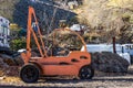 Retro Orange Fork Lift In Salvage Yard