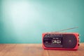 Retro outdated red portable radio cassette recorder from 80s front blue background. Vintage old style photo Royalty Free Stock Photo