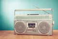 Retro outdated silver portable stereo radio cassette recorder from 80s front blue background. Vintage old style photo