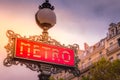 Retro Paris Metro sign in Montmartre, Paris at sunset, France