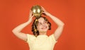 Retro party. Child hold golden disco ball. Cheerful girl with disco ball. Fashion kid posing with curlers in hair. Night Royalty Free Stock Photo