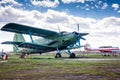 Retro passenger biplane and small sports airplane at the ground airfield Royalty Free Stock Photo