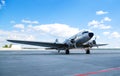 Retro passenger plane on the runway. sunny summer day with clouds