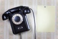 Retro phone and blank on a wooden wall Royalty Free Stock Photo