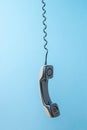 A retro phone handset hanging on a stretched wire Royalty Free Stock Photo