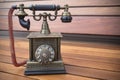 Retro Phone model, vintage old dial Telephone on wood background