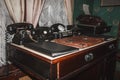 Retro phones, vintage cash register, old printing machine, folders and briefcase