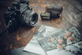 Retro photo camera, film and old photos on the table Royalty Free Stock Photo