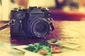 Retro photo camera, film and old photos on the table Royalty Free Stock Photo