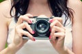 Retro photo camera in girl hands Royalty Free Stock Photo