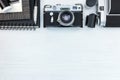 retro photo cameras, frame, notebook, pen, negative films on white wooden background Royalty Free Stock Photo