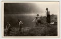 Retro photo shows a group of boys goes into the river. Summer vacation view. Vintage black and white photography.