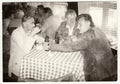 Retro photo shows men in the pub - inn. Vintage black and white photography.