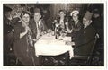 Retro photo shows social event - celebrating of New Year's Eve. Circa 1950s