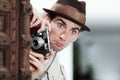 Retro photographer man, street and camera on investigation, inspection or suspicious journalist job in city. Private Royalty Free Stock Photo