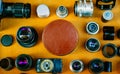 Retro photographic mockup. Closeup round leather vintage box in center and vintage photographic accessories and quipments around.