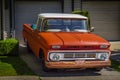 Retro pickup truck on a sunny summer day. Orange Chevrolet C10 Pick Up Truck. Vintage Chevy truck parked on a street Royalty Free Stock Photo